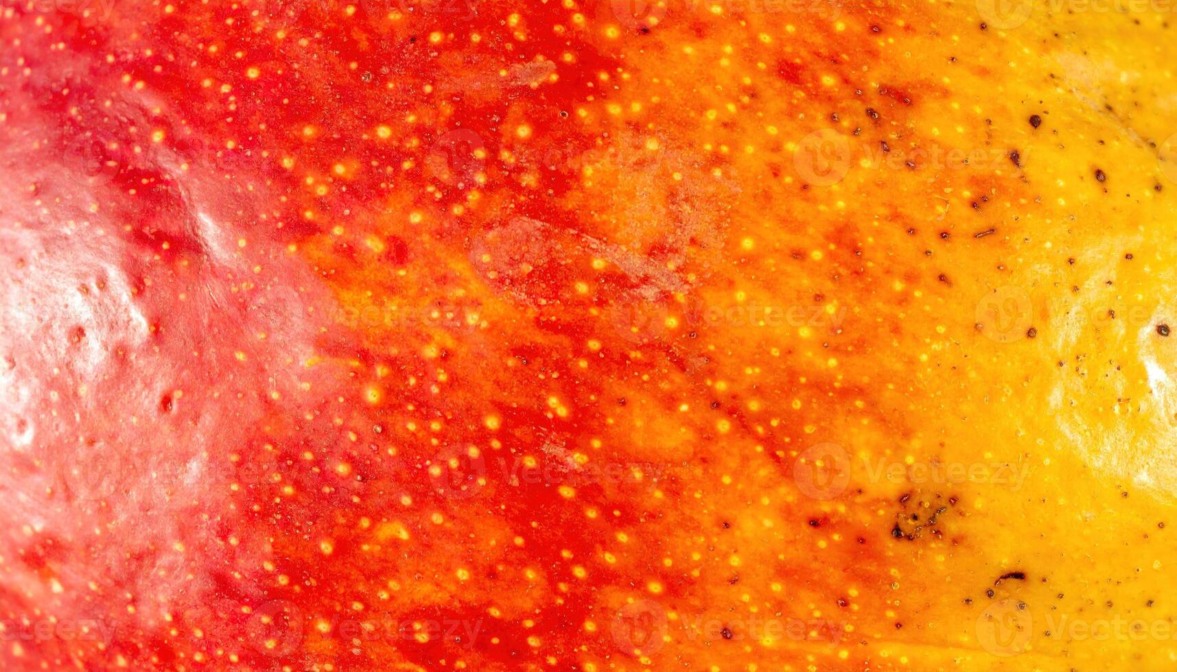 Close-up captures vibrant, textured surface with gradient hues of red, orange, and yellow. Tiny dots and subtle imperfections add character to the natural pattern photo