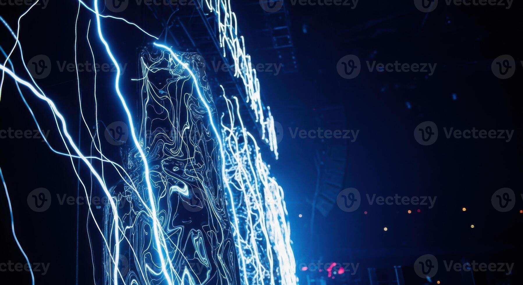 A man is standing in front of a large light display photo