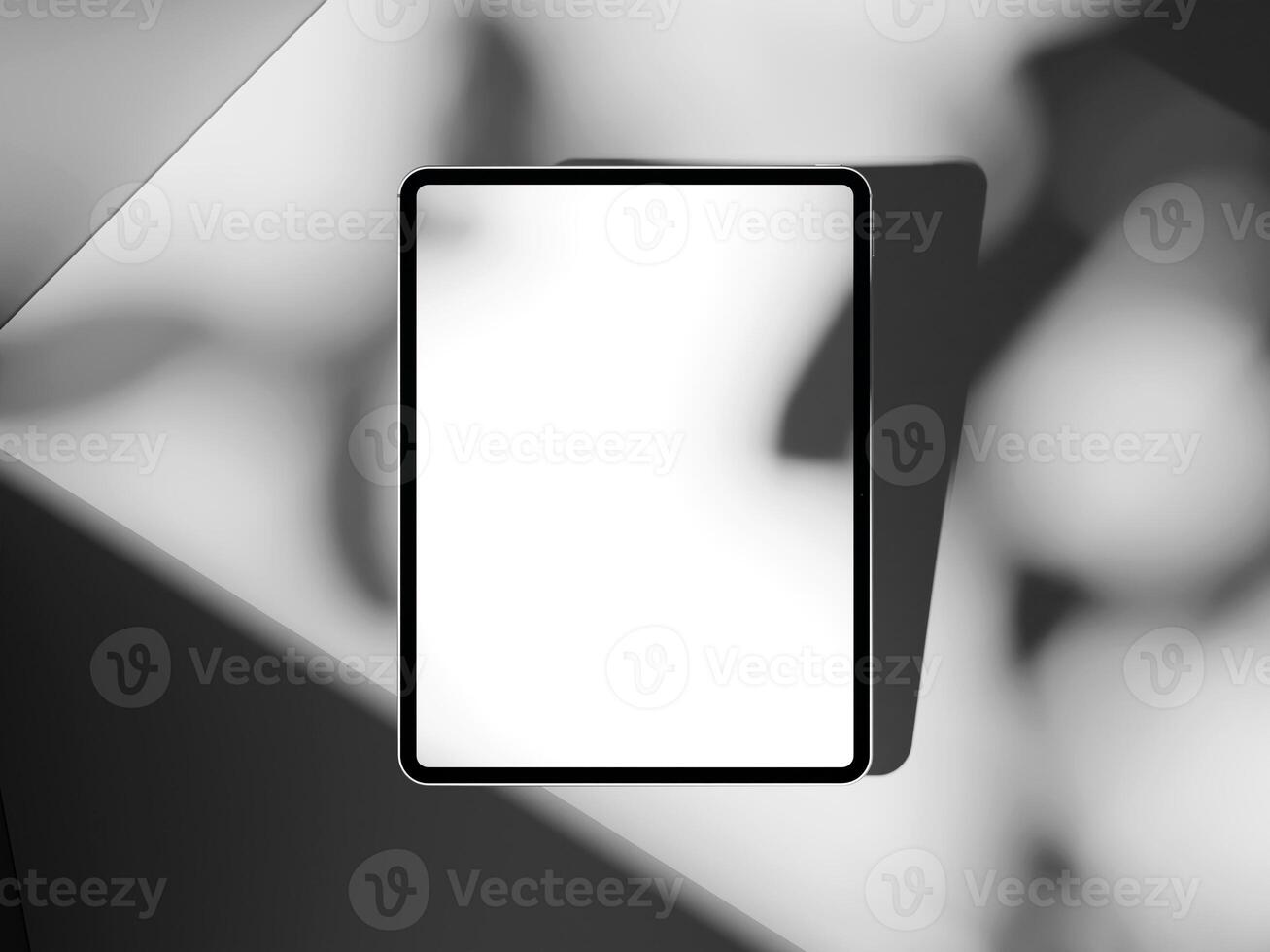 Simple tablet mockup with shadow play on cement, suitable for tech or app showcase presentations. photo