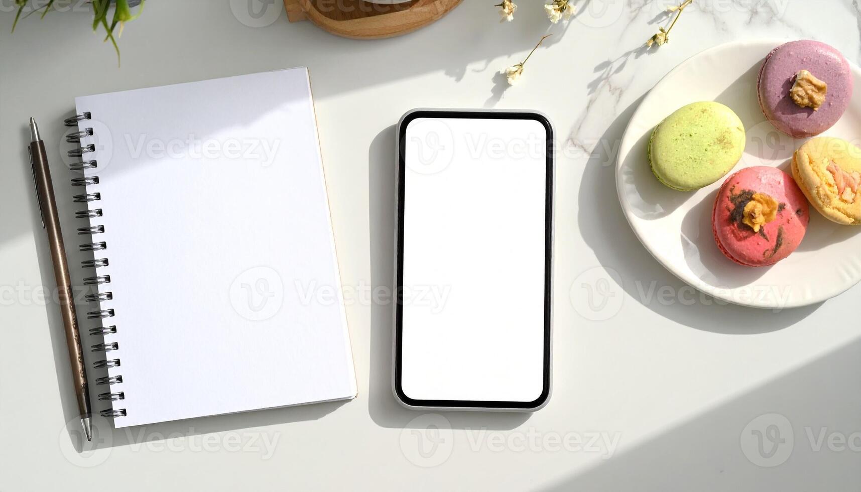 Minimalist Workspace with Phone Notebook and Macarons. photo
