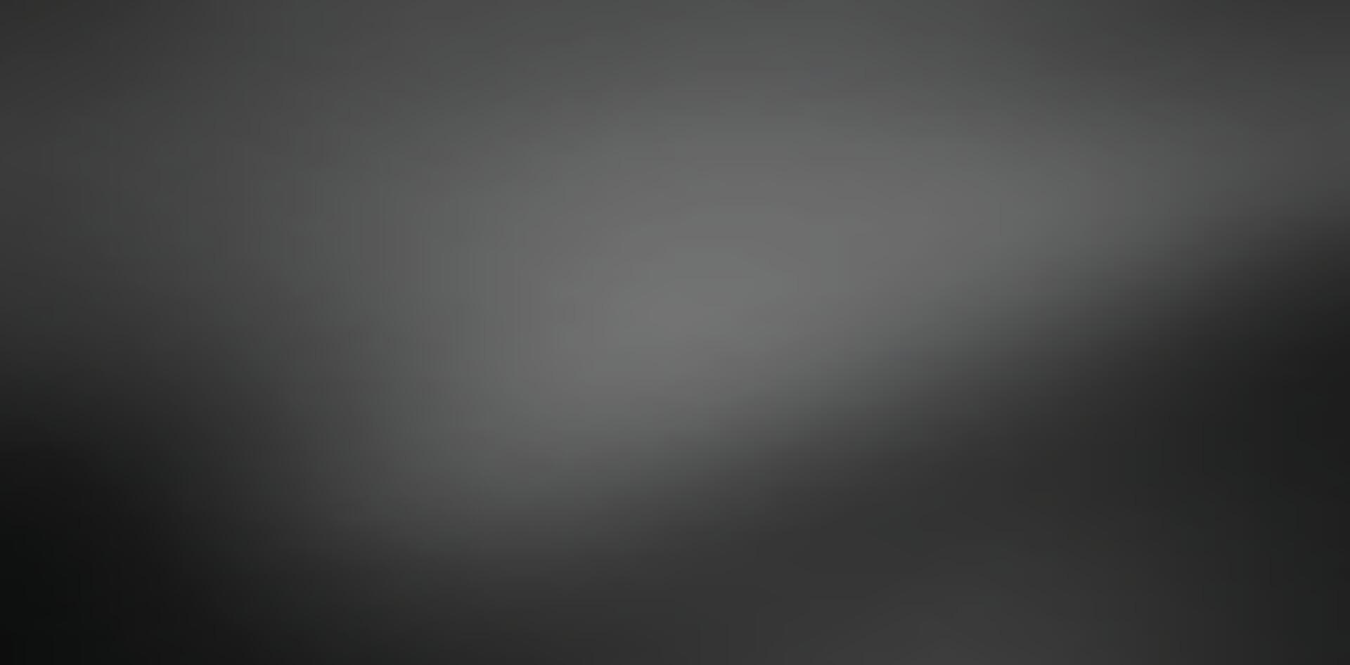 A blurred monochrome image showcasing a gradient of light and dark shades, creating a soft and abstract visual effect.black and gray gradient background vector