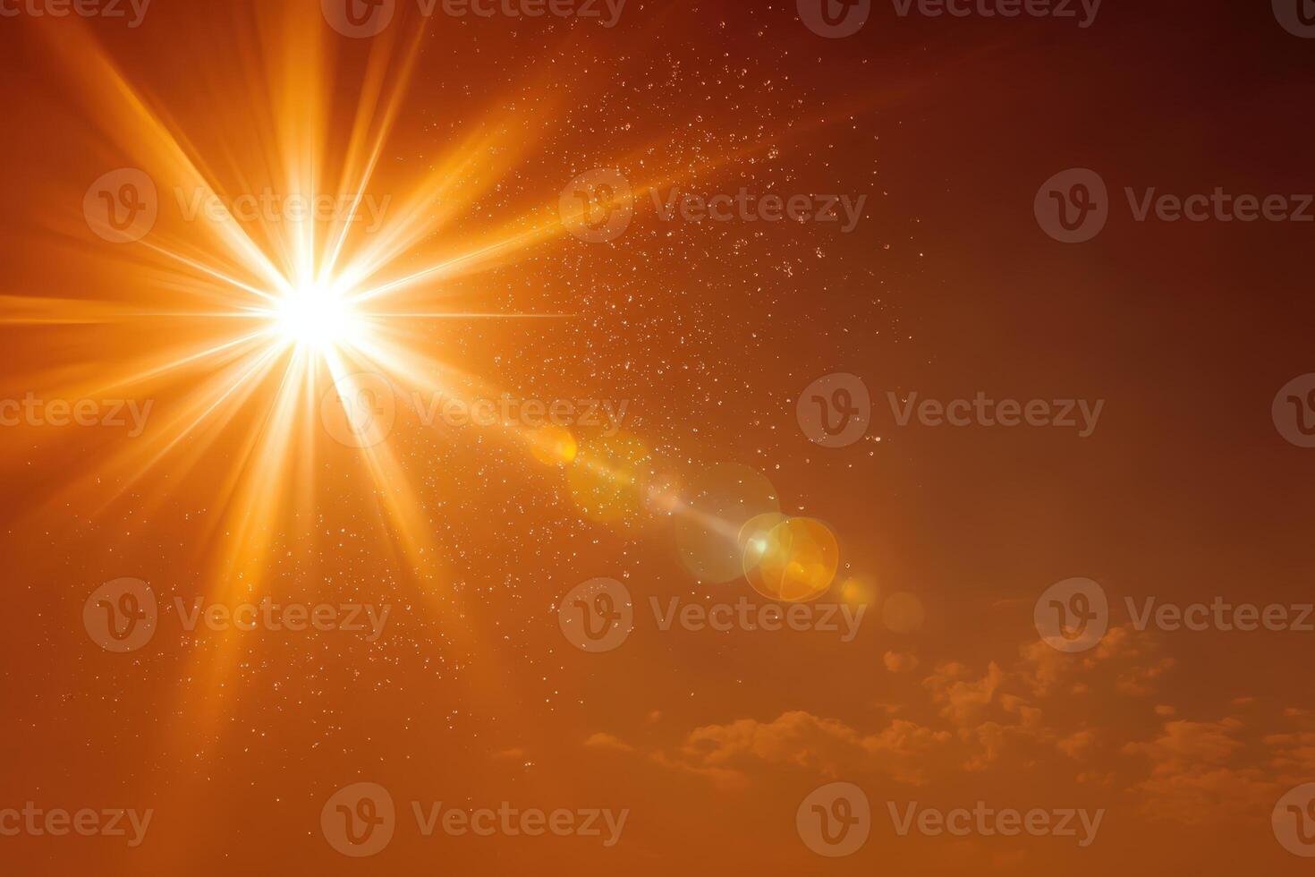 Bright sunburst radiating warm light through a vibrant orange sky, creating a stunning visual effect with soft clouds and sparkling particles in the atmosphere photo