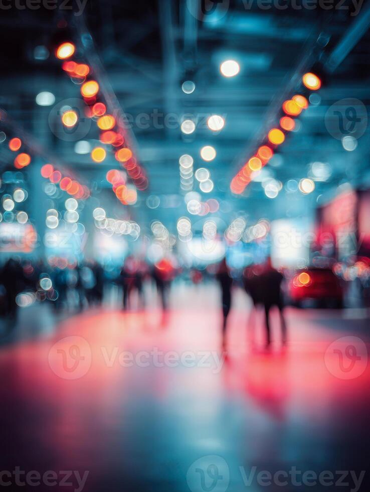 Abstract blurred view of a busy indoor event hall with colorful lights and people moving, creating a vibrant atmosphere full of energy and motion photo