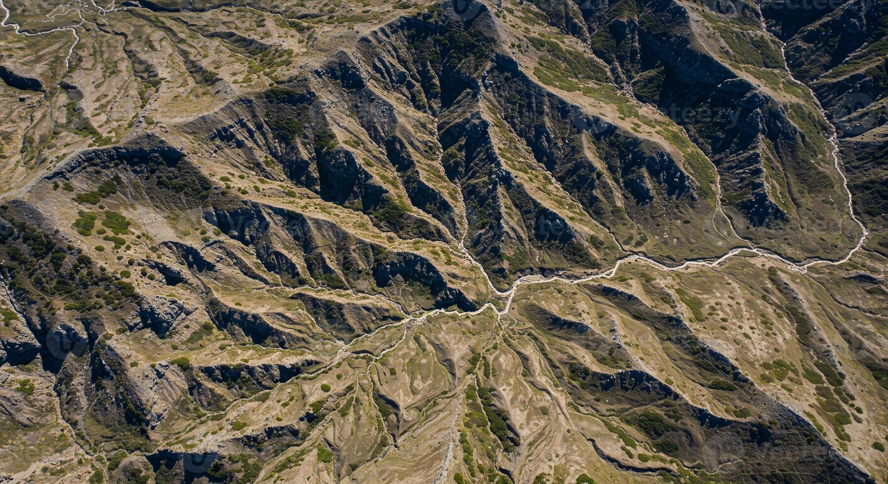 Aerial View of Rugged Mountain Range with Varied Terrain and Natural Patterns. photo