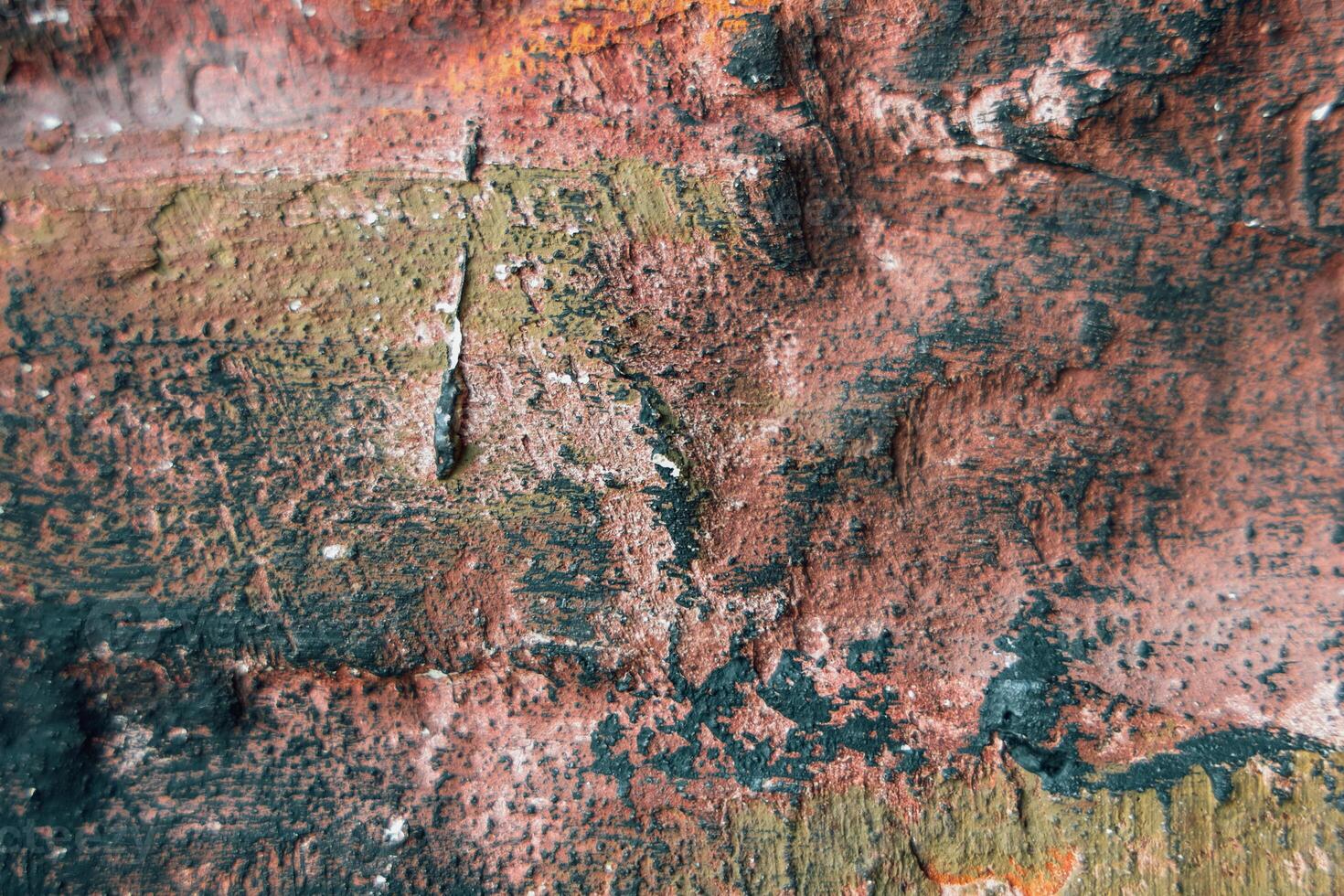 Colors blend on textured surface creating an abstract design in a weathered setting photo