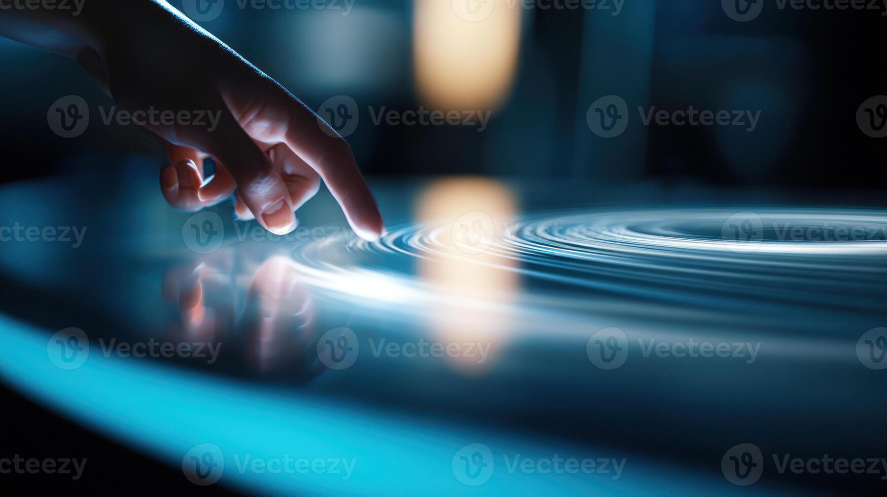 A person touching a circular object on a table photo