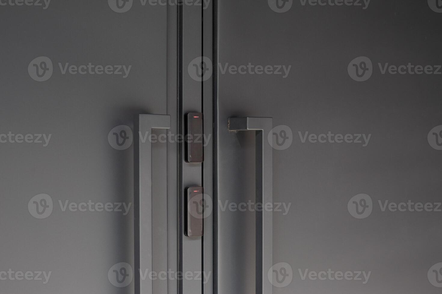 Close up of modern black doors with smart access control system, featuring minimalistic design and security technology, emphasizing convenience and sophistication in urban spaces photo