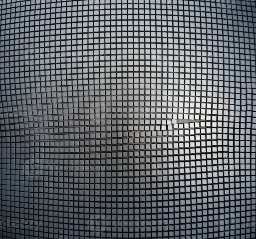 Close up of a fine mesh screen with a subtle metallic sheen and grid pattern photo