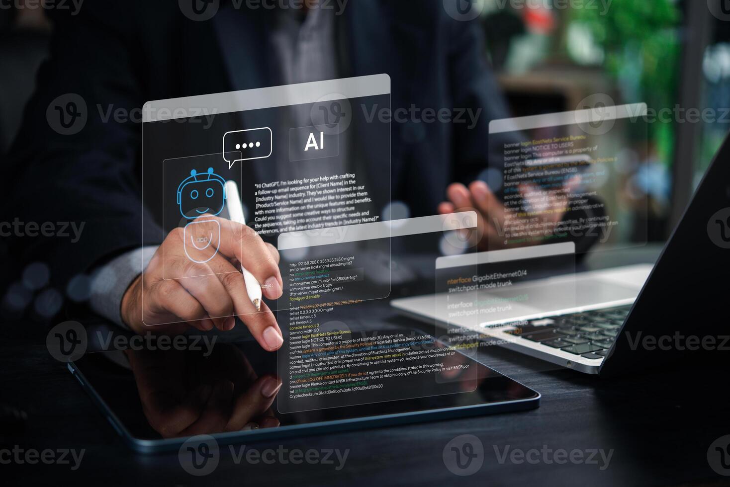 A man using a tablet with a digital interface and a laptop with a digital interface photo