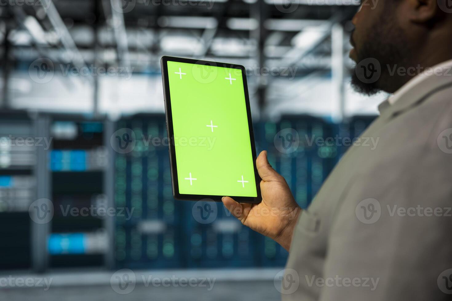 Close up of data center software developer using isolated screen tablet, managing energy consumption. IT expert using chroma key device used for automation and monitoring processes in server farm photo