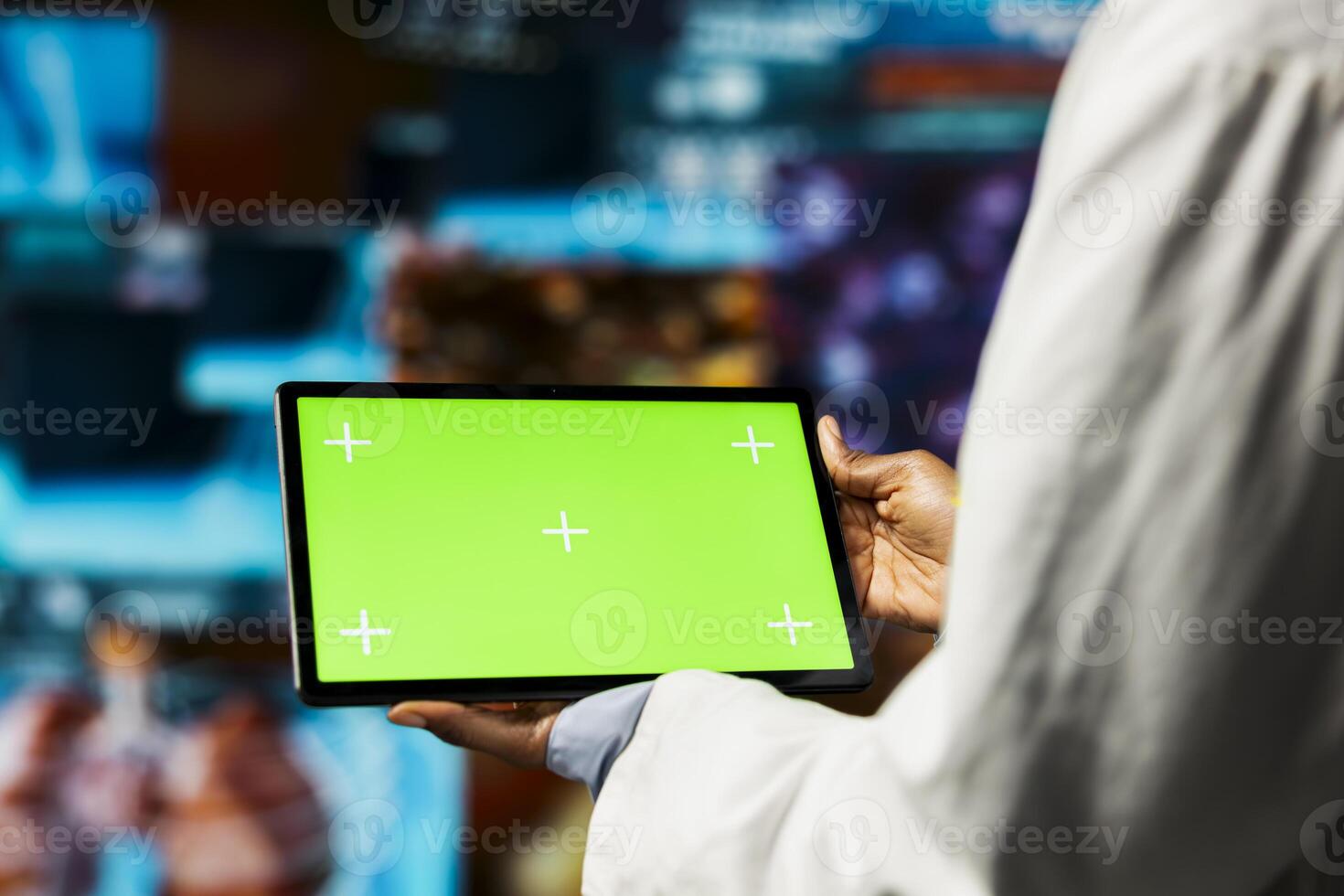 Healthcare specialist uses isolated screen tablet app, reviewing CT scans and MRI data analytics. Scientist in medical research lab visualizing health data on futuristic panels using chroma key device photo