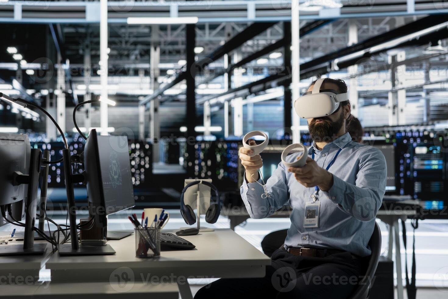 Technician using VR headset in data center to update server tech, configuring equipment using software tools. Server room employee reviewing hardware analytics using virtual reality photo