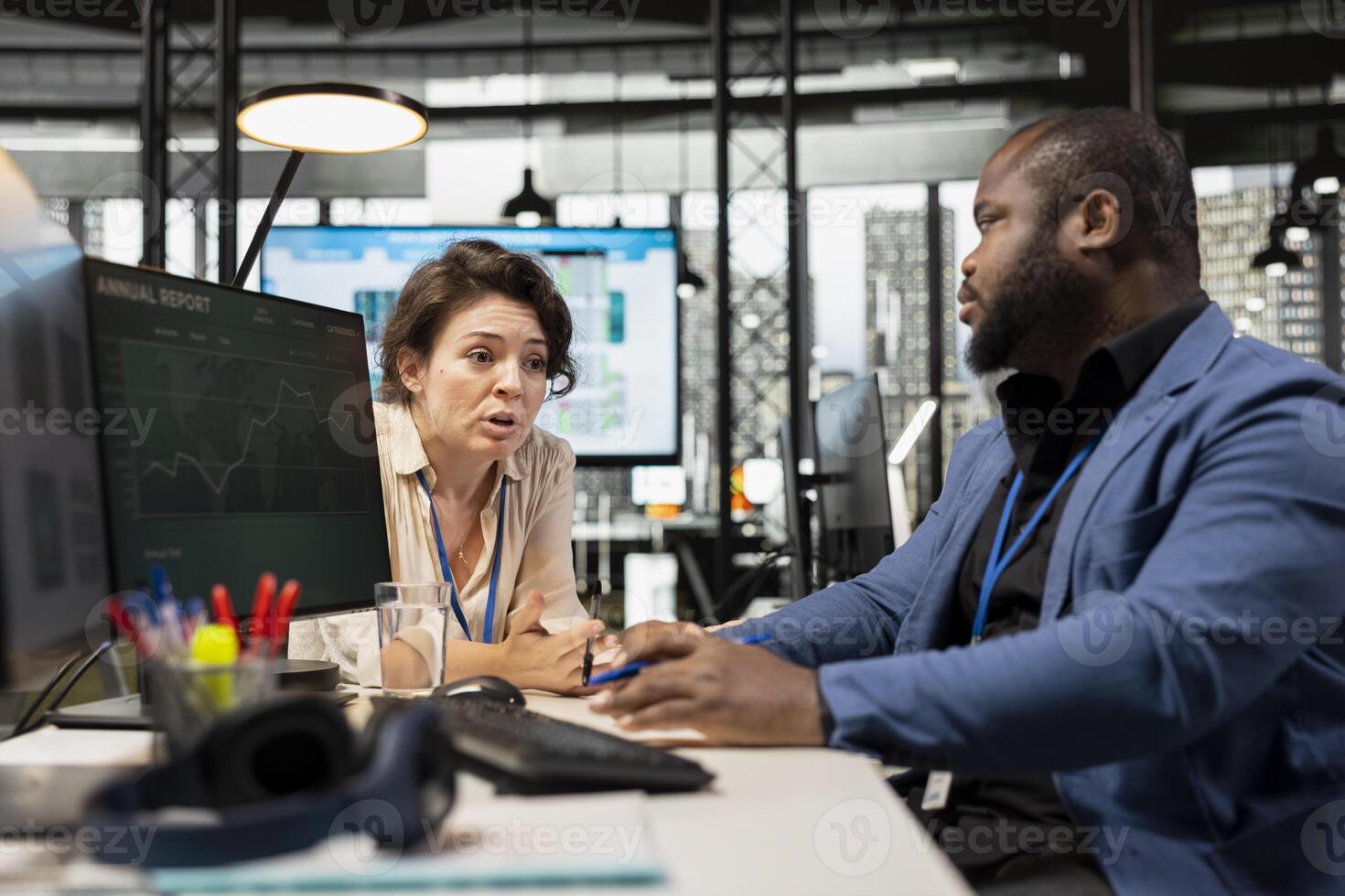 Manager and assistant reviewing monthly data charts to create reports, applying business strategy and analysis to drive innovation and improve company performance. Work alliance. photo