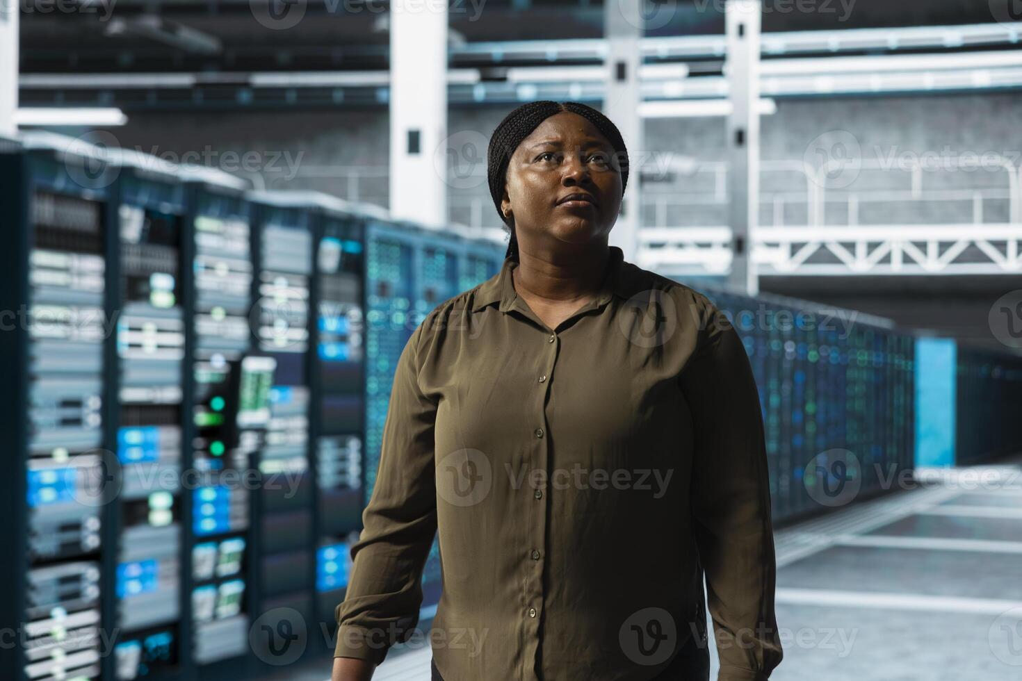 Engineer walking through server farm rows lined with storage infrastructure rigs. IT expert inspecting data center facility helping power online services for enterprise customers photo
