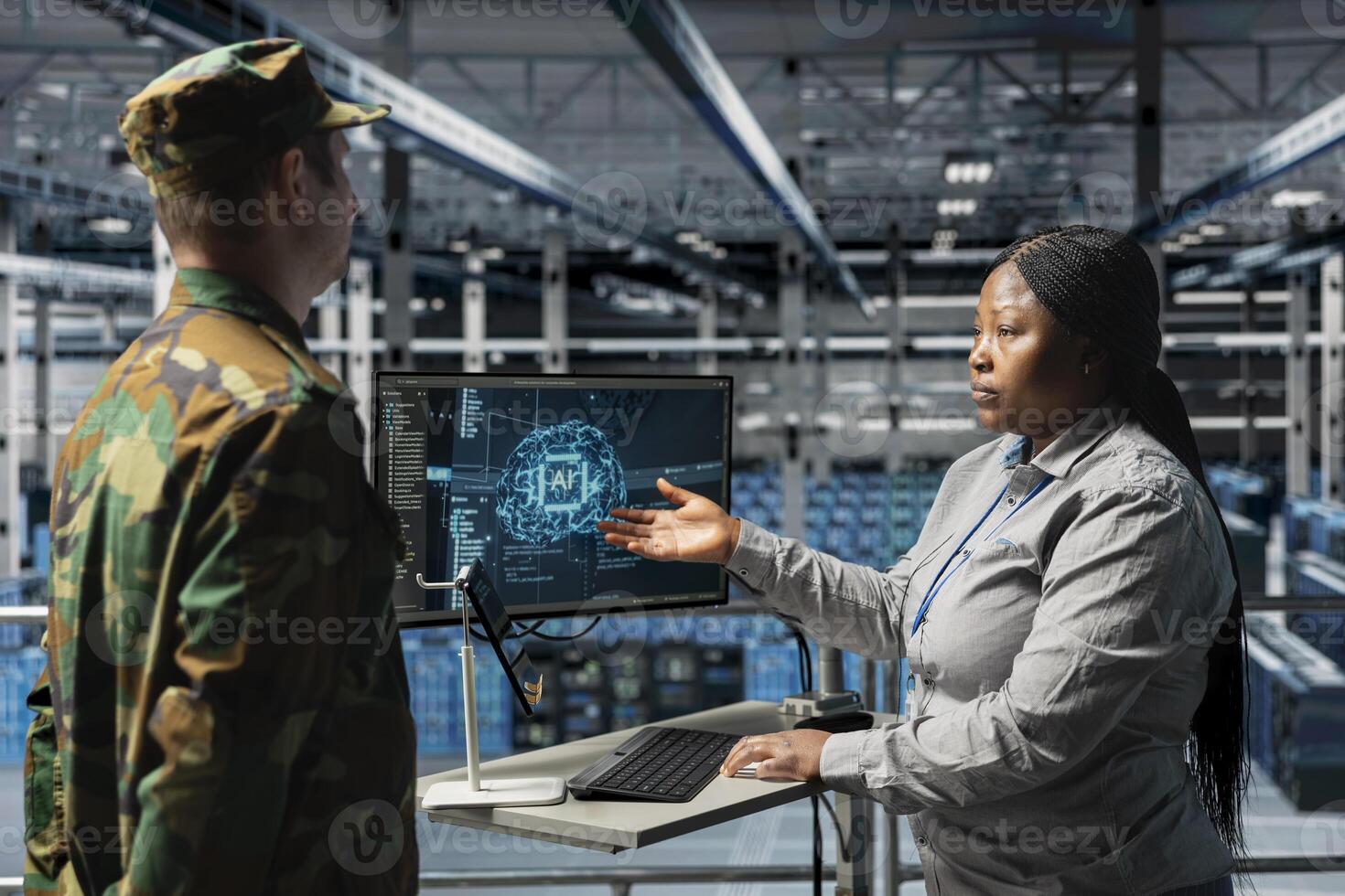 Army tech expert in data center relaying AI battlefield analysis to commanding officer. Server farm workers discussing threat detection results powered by artificial intelligence photo