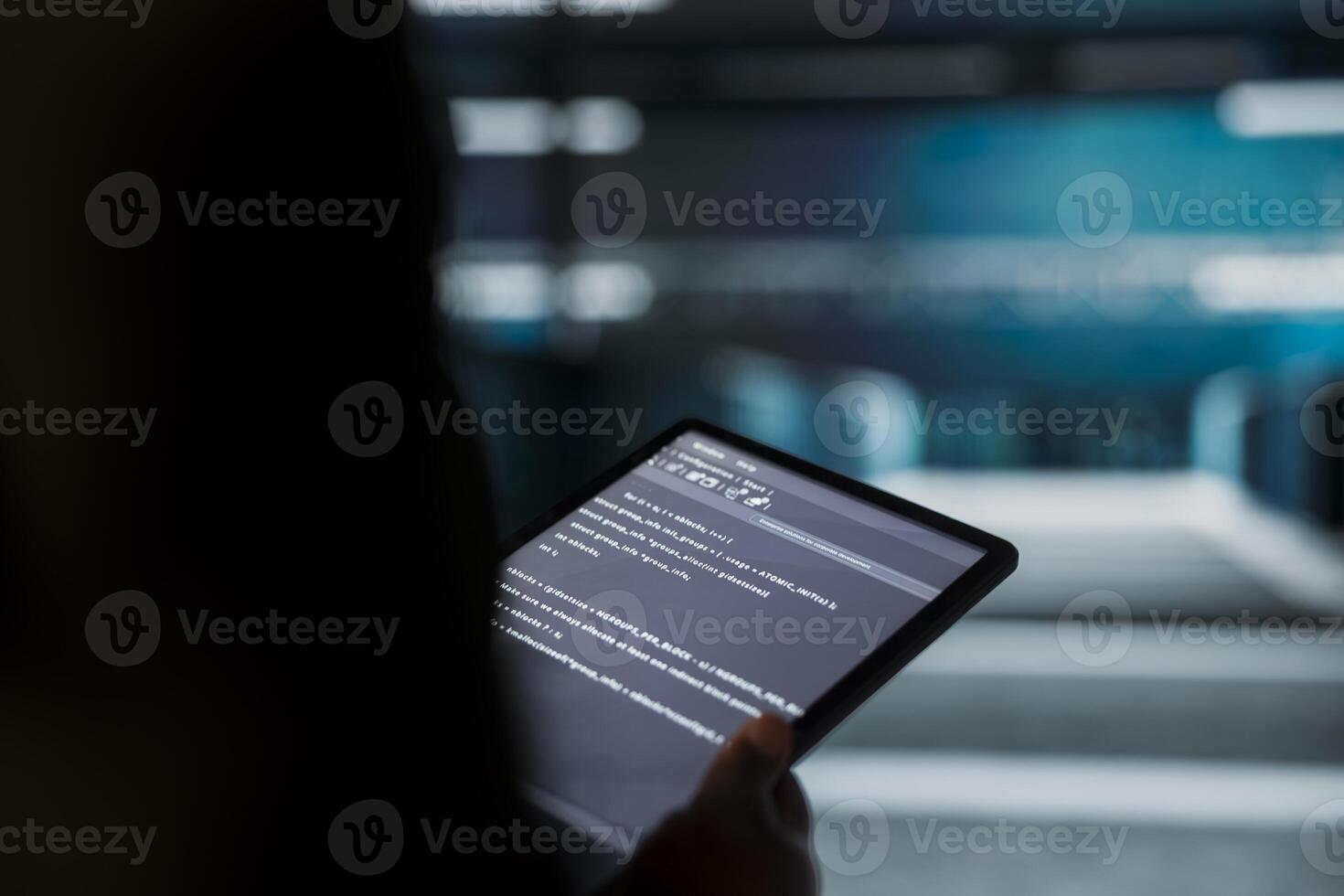 Close up of engineer using tablet in sustainable data center, implementing green technologies. IT expert working on energy efficient solutions to reduce server farm carbon footprint photo