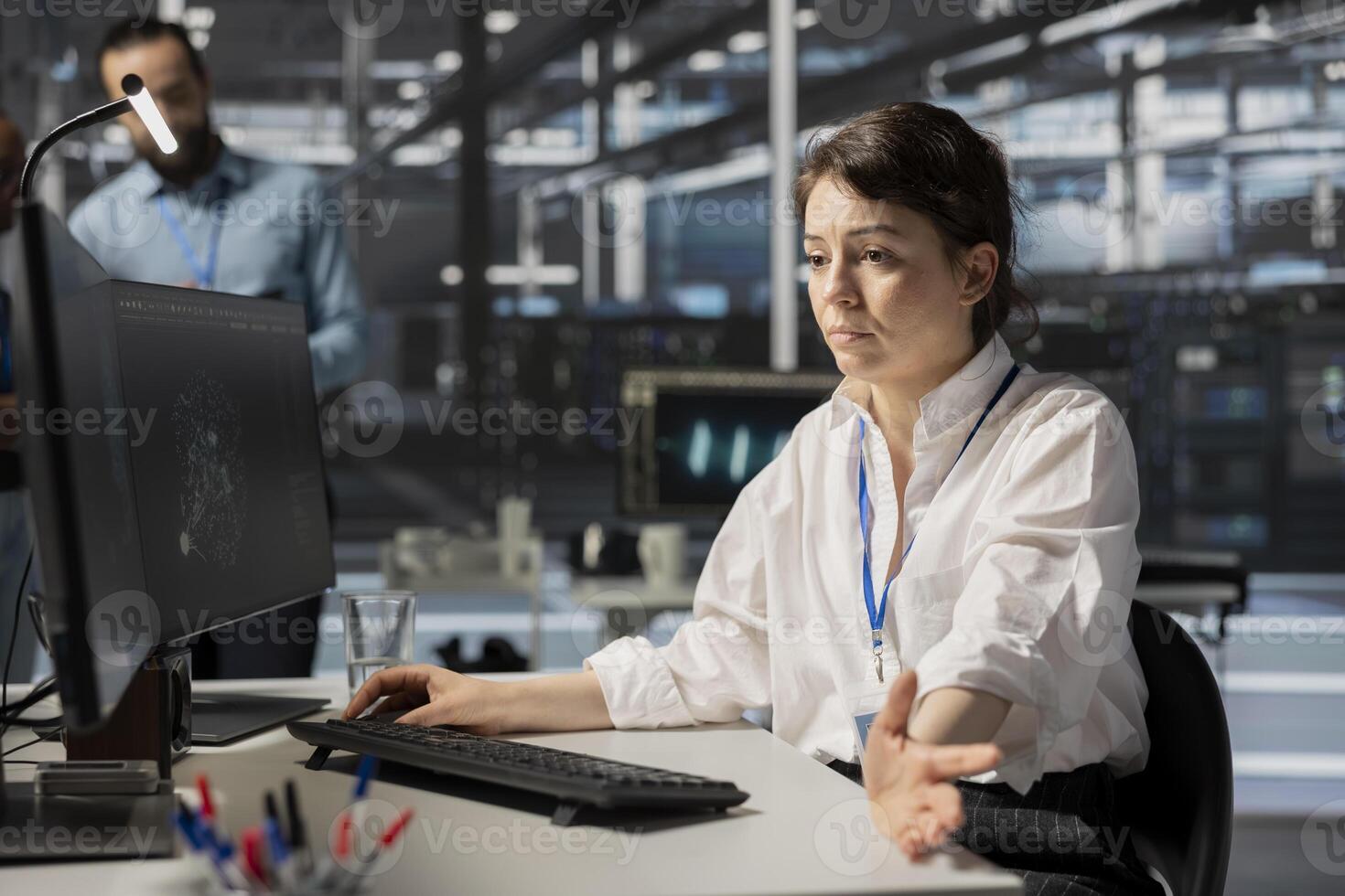 Data center programmer inspecting gear, doing maintenance tasks, checking performance. Server farm It specialist conducting system checks to ensure operational stability across network mainframes photo