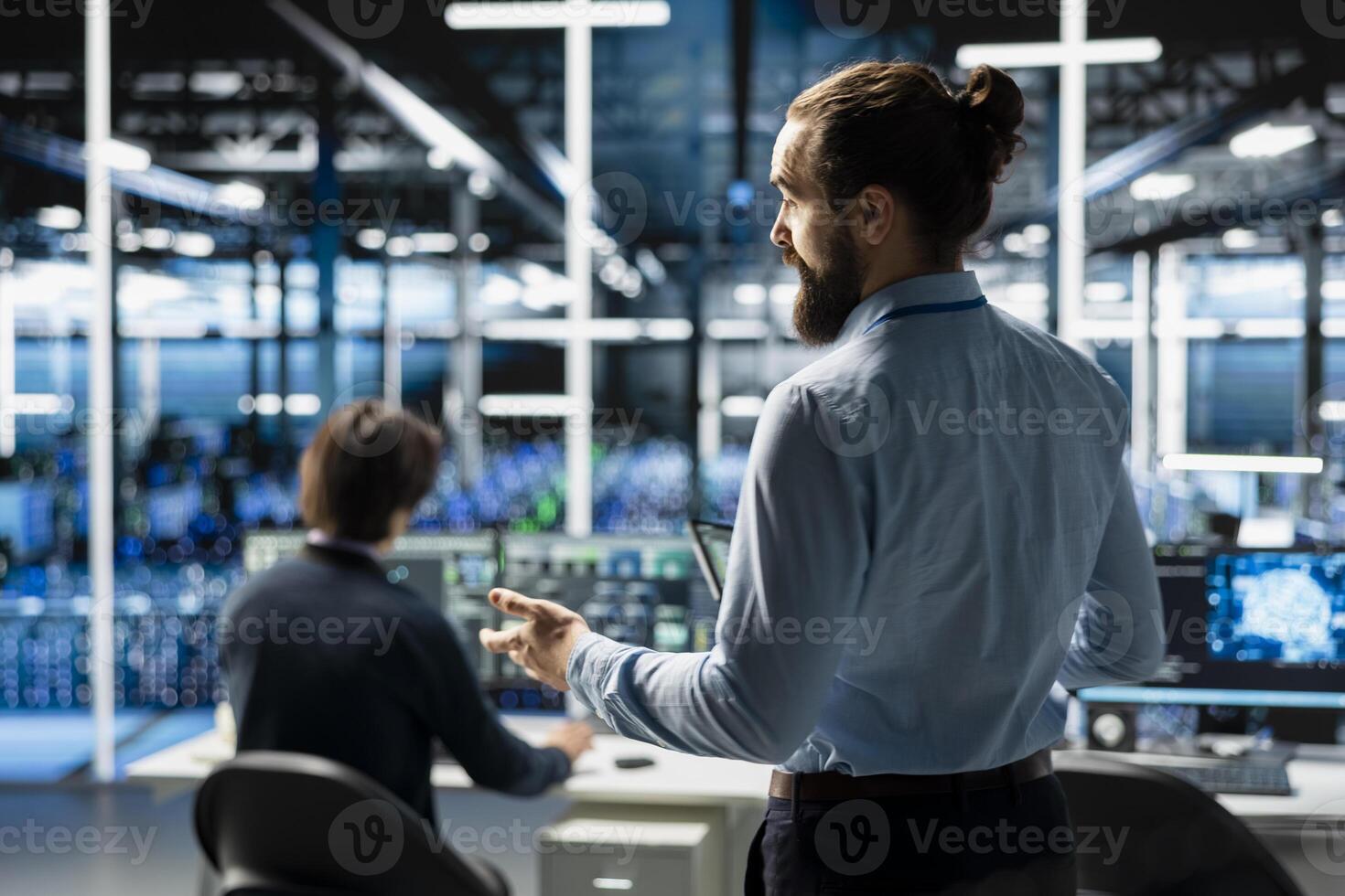 Teamworking admins coding in data center, updating AI driven automation scripts. Server room colleagues programming artificial intelligence algorithms, debugging infrastructure photo