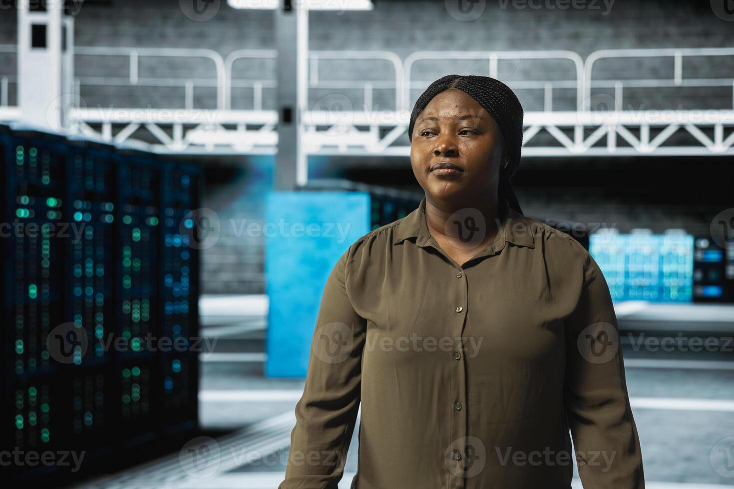 System administrator walking through server farm rows lined with storage infrastructure rigs. IT specialist inspecting high tech data center helping power online services for enterprise customers photo