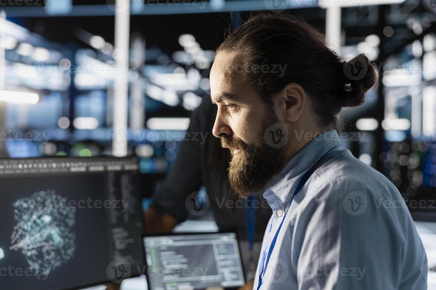 Data center technician programming diagnostic scripts on PC, examining infrastructure. Close up of server farm employee evaluating performance metrics, running tests to maintain system stability photo