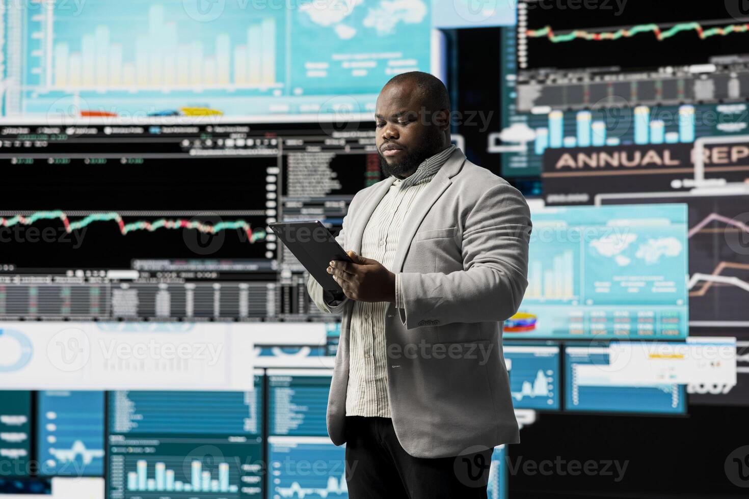 Young businessman thinking about a new solution to increase funds, evaluating statistics and financial reports with digital technology and analytics. Long term success and growth. photo