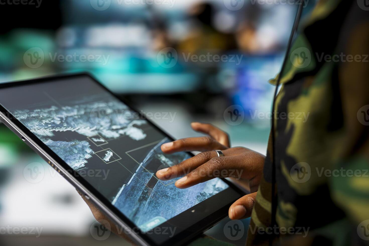 Close up of military defense security agent using device to track threats. Counterterrorism division officer in command post using target acquisition tech on tablet to detect enemy location photo