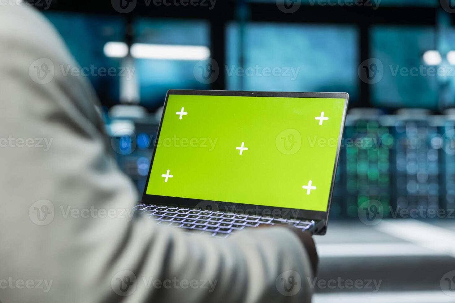 Close up of programmer in data center using green screen laptop to check for server performance issues. IT professional in server hub fixing errors slowing down hardware using mockup notebook photo