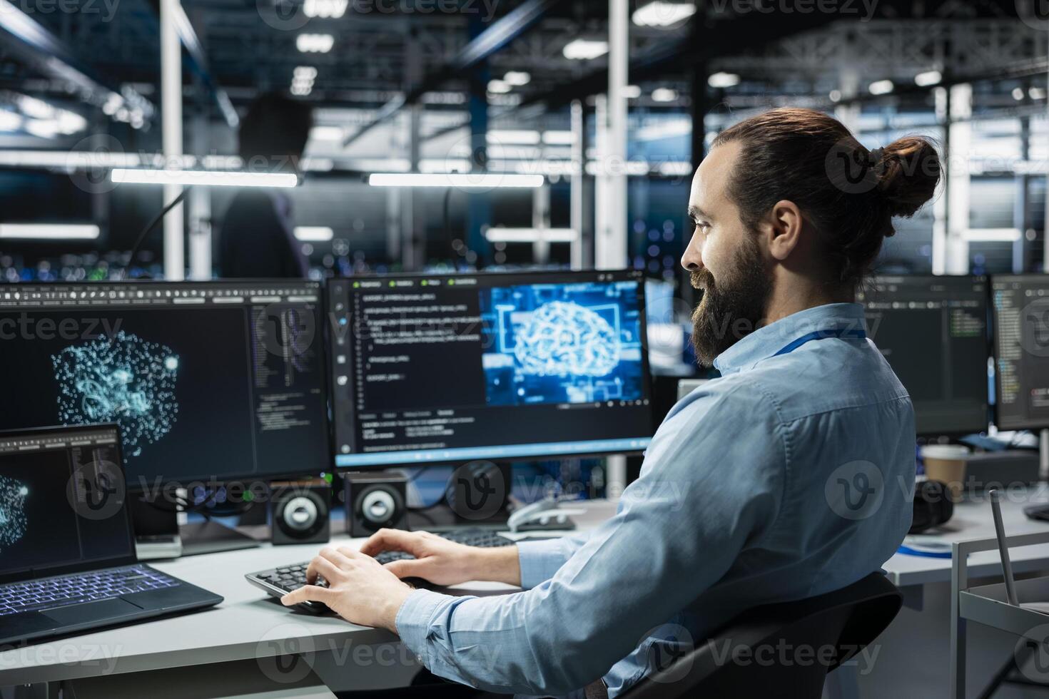 Jolly data center technician working on databases supporting AI apps. Upbeat IT employee in server room using artificial intelligence technology on PC to do algorithms improvements photo