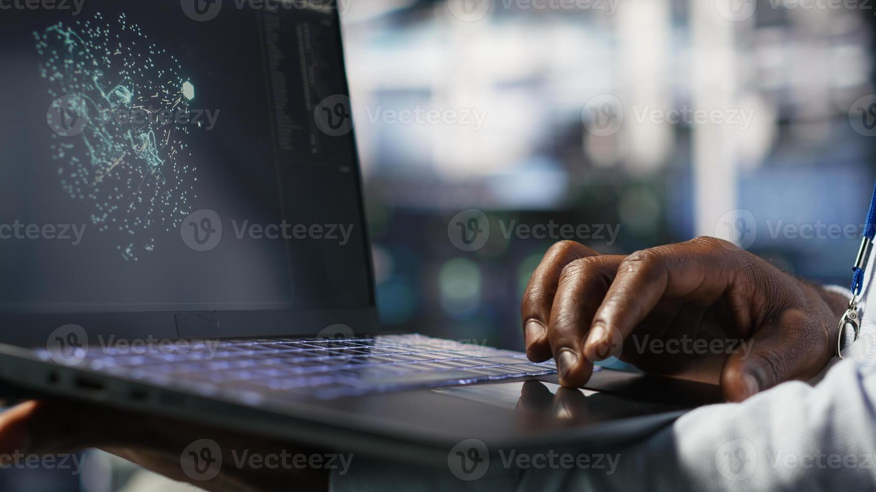 Close up of data center worker using laptop to interpret data analytics graphs. Server room technician using artificial intelligence on notebook displaying system metrics, camera B photo