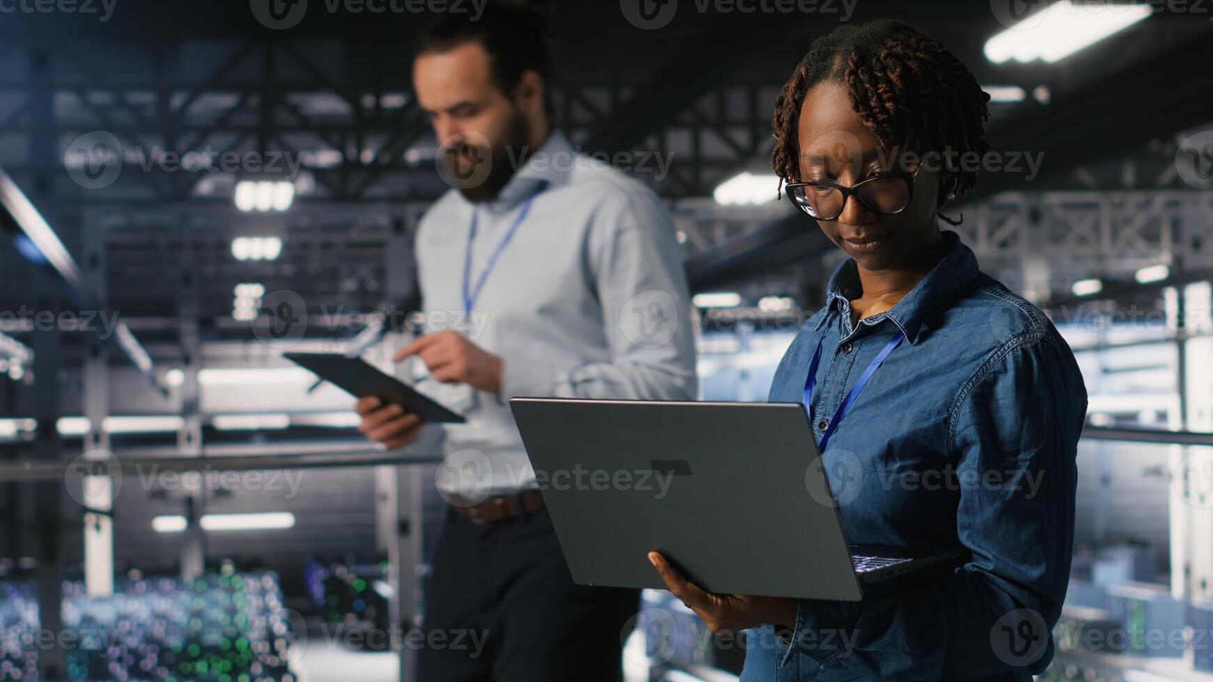 Data center teamworking colleagues running diagnostics on equipment to identify errors, doing brainstorming. Engineering team preventing rigs failure to minimize downtime photo