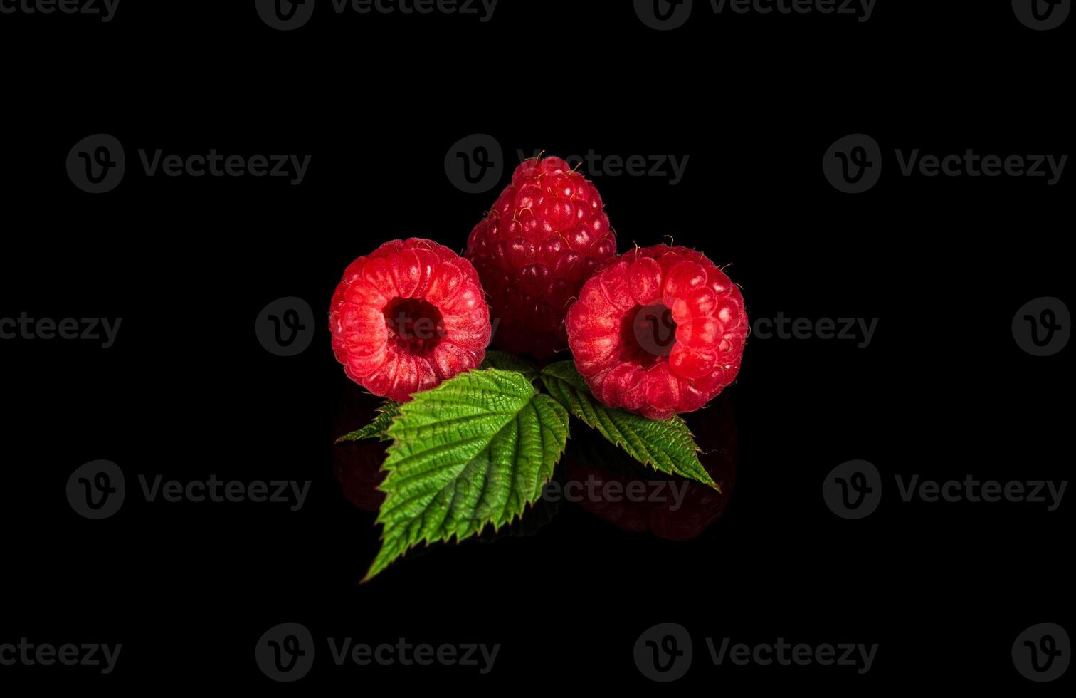 Raspberry isolated. Raspberries with leaf isolate. Raspberry with leaf isolated on black background. photo