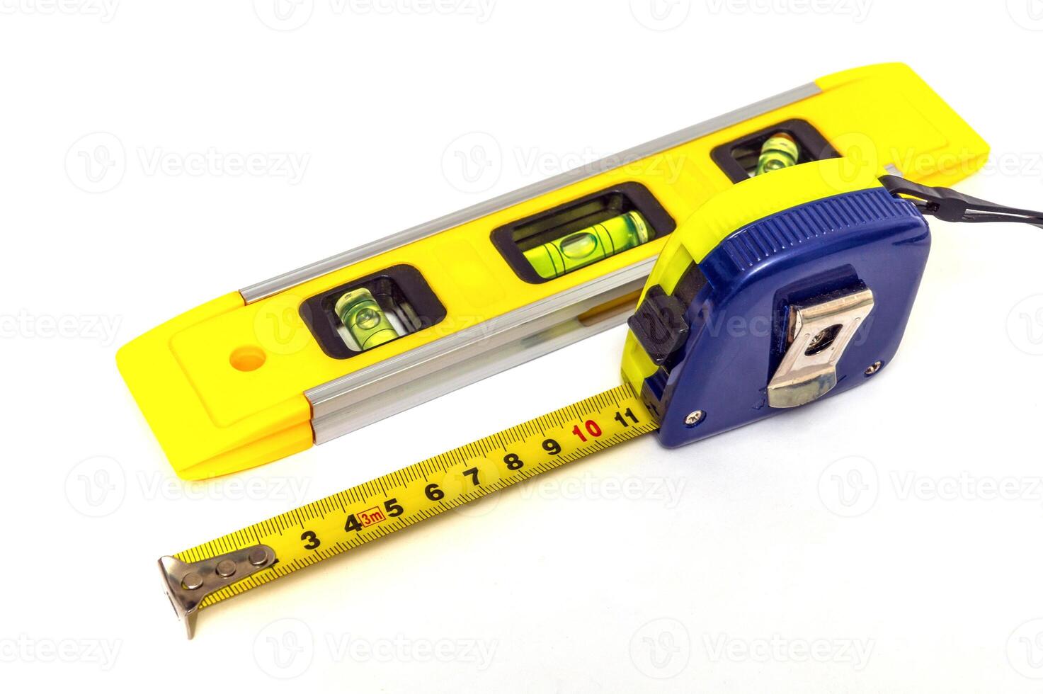 Building level and tape measure for leveling or measuring objects on white background photo