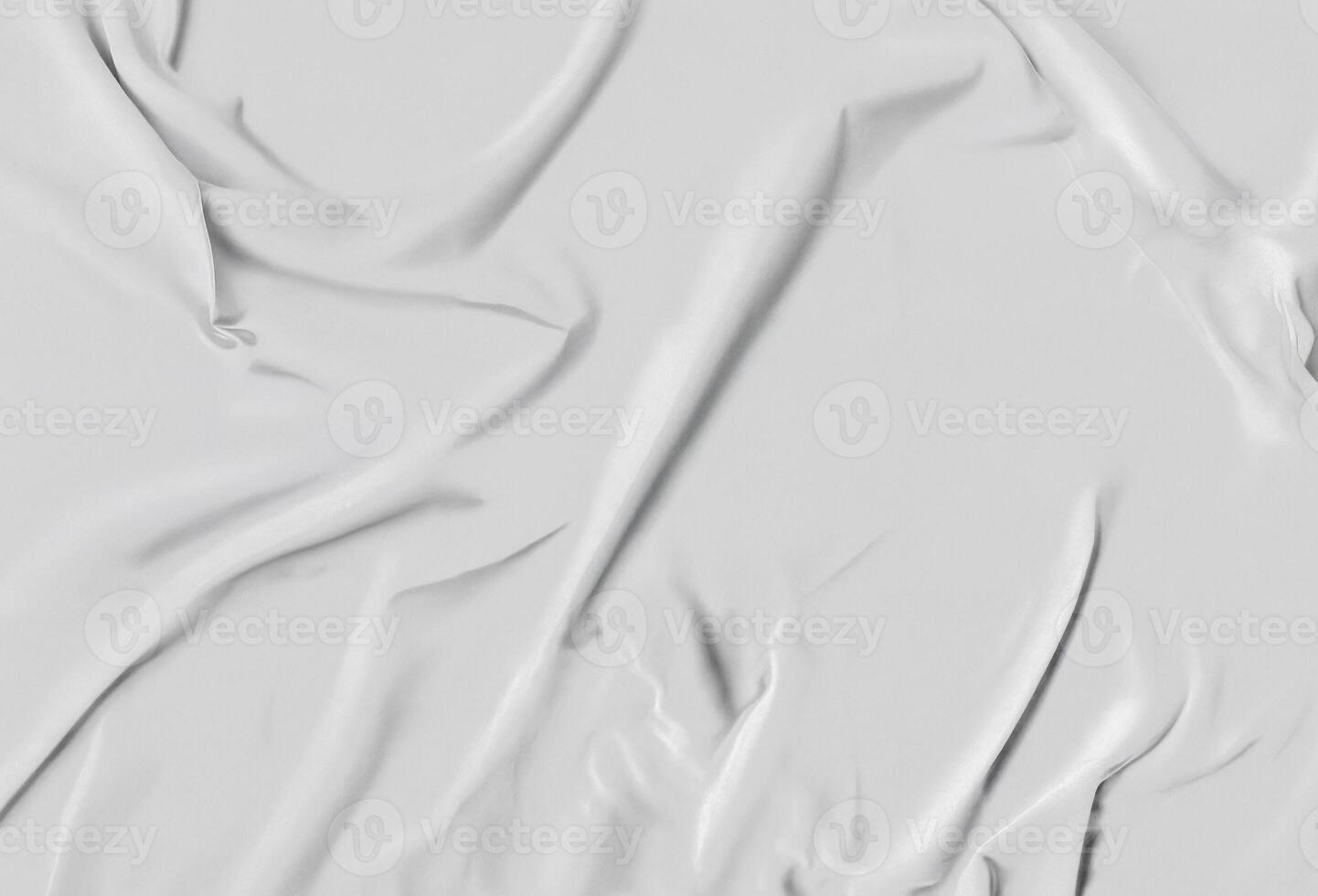 Close-up of wrinkled white fabric with delicate folds and light shadows. Minimal textured background ideal for design mockups, fashion templates, and creative presentation visuals. photo