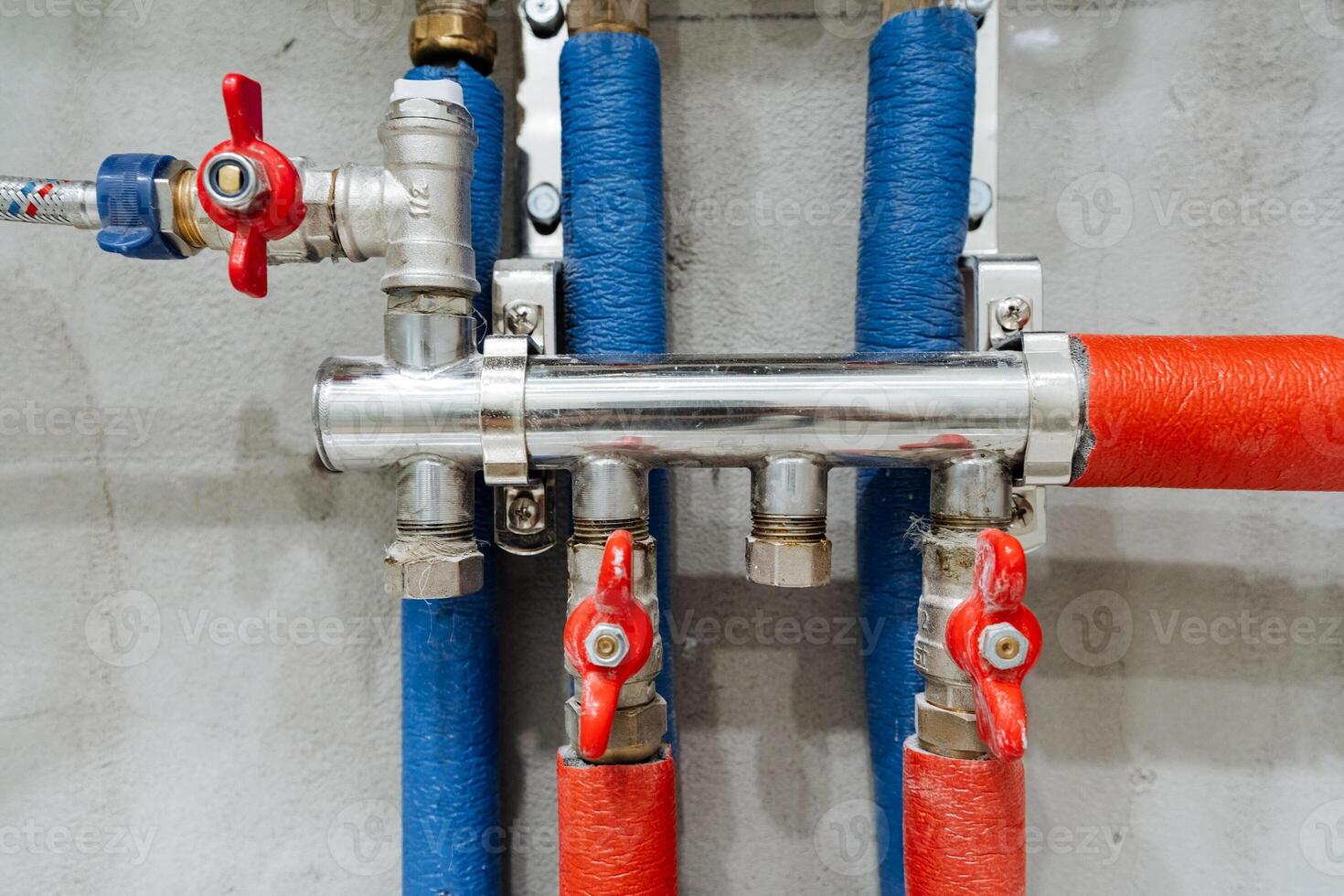 An intricate industrial pipeline system features strong metal valves and a complex layout of colorcoded hoses, designed for efficient fluid movement and management in the workspace photo