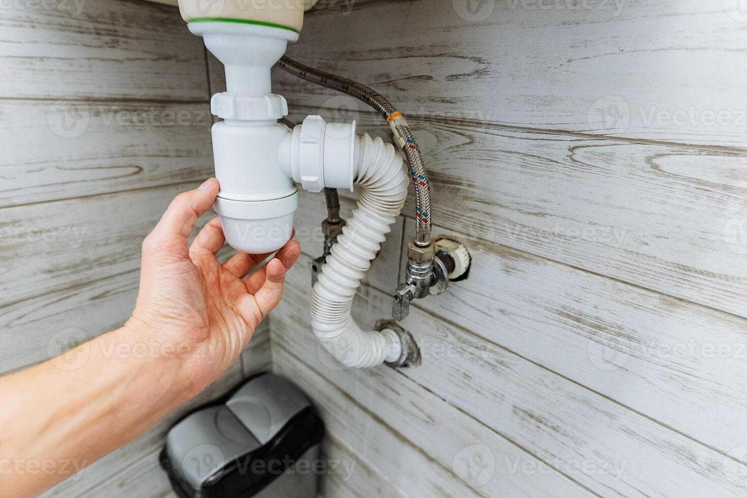 A homeowner is currently enhancing the drainage system in their kitchen by adjusting the configuration of the drain pipes and adding a Ptrap along with a flexible hose for improved efficiency photo