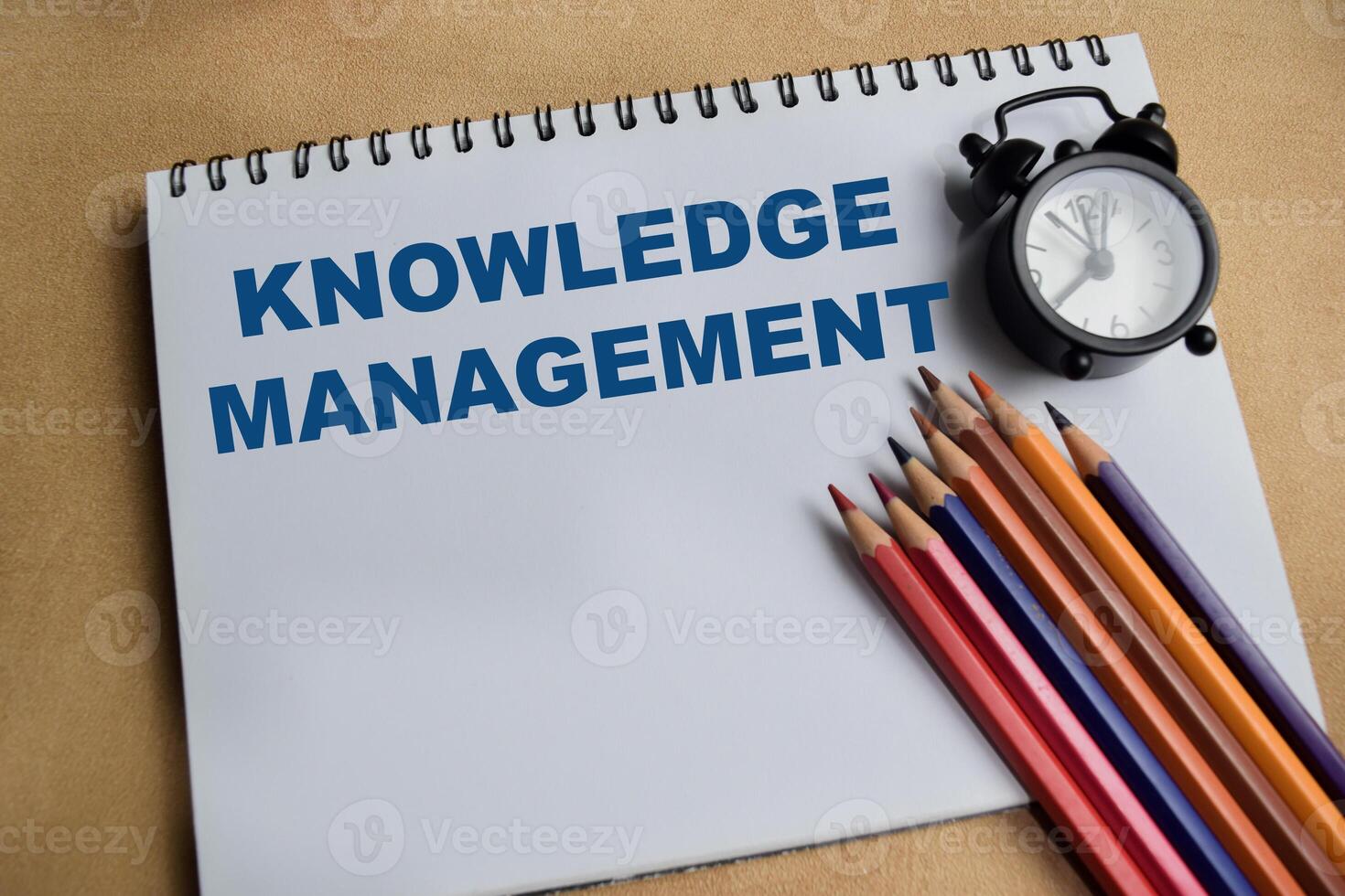 Concept of knowledge management write on book with keywords isolated on Wooden Table. photo