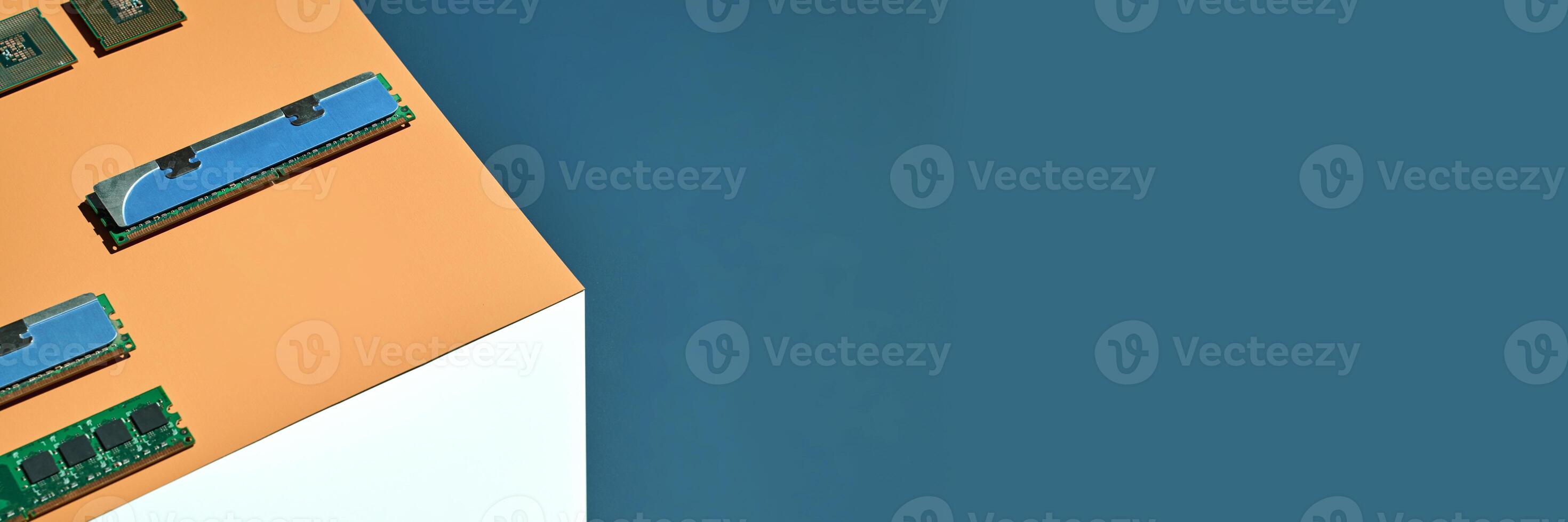 Computer memory modules and processors on corner against blue background tech hardware overview. photo