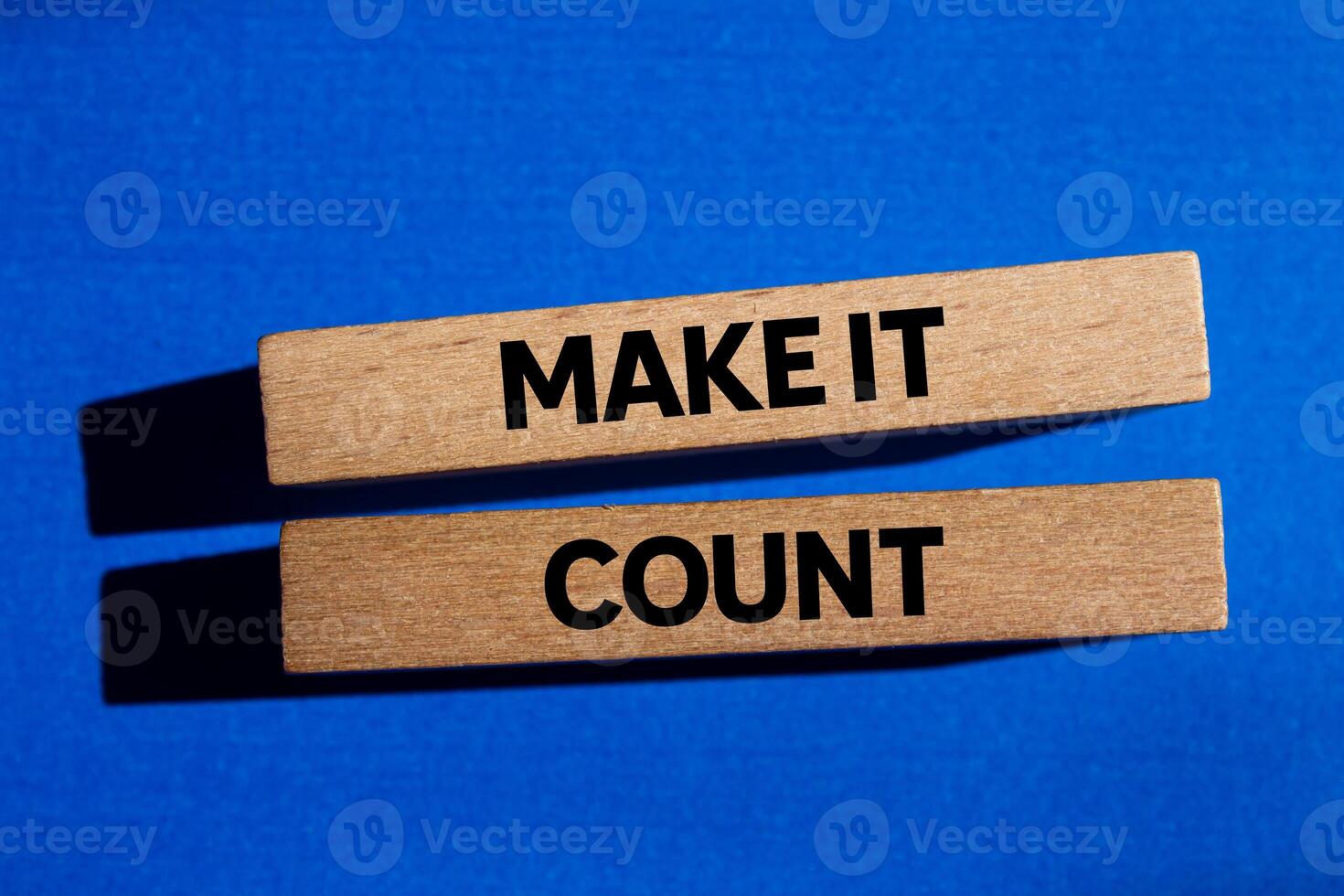 Make it count message written on wooden blocks on blue background. Conceptual make it count symbol. Copy space. photo