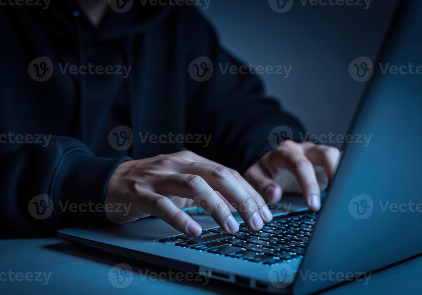 Hacker hands rapidly typing on laptop keyboard in dark, intense cyber scene photo