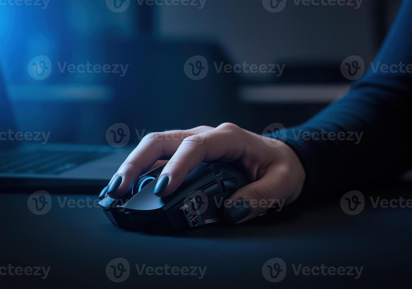 Focused hand using a computer mouse with blue light in a dark digital workspace photo
