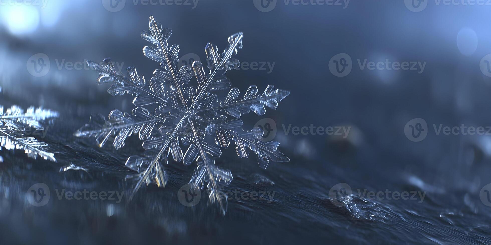 A detailed macro image of a clear intricate snowflake on a dark textured surface with soft blue bokeh lights photo