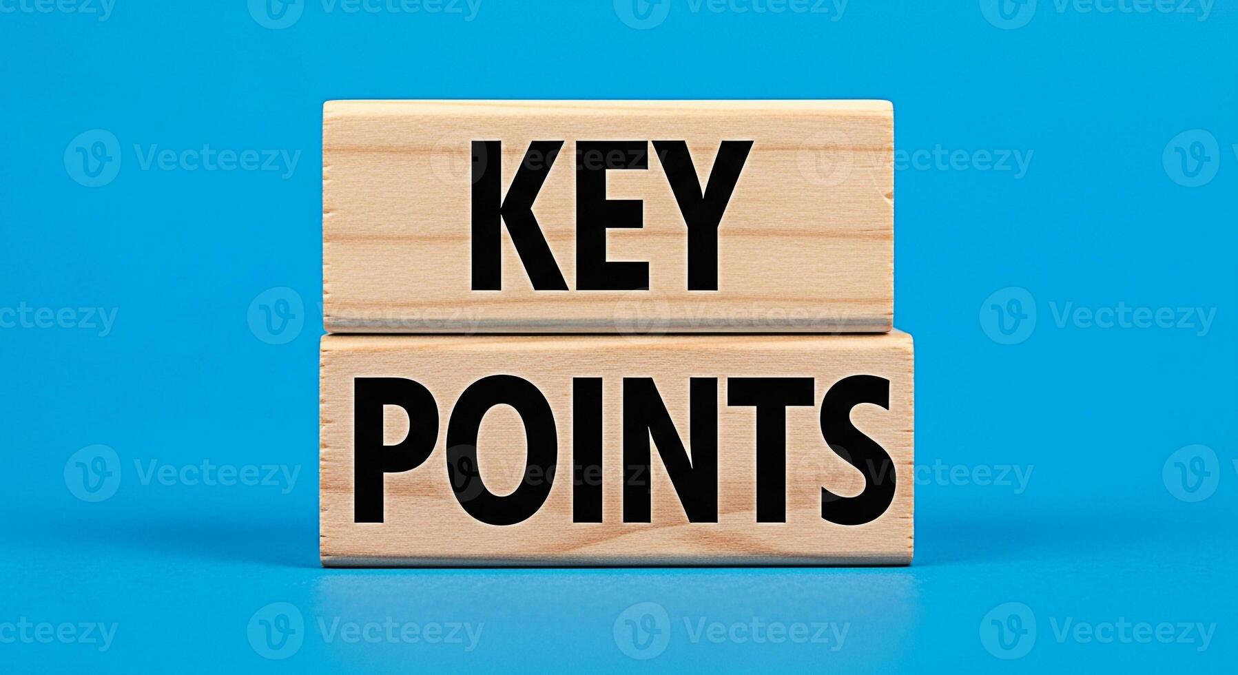 Stacked wooden blocks displaying the words Key Points on a bright blue background emphasizing essential information and critical elements for effective communication and strategic planning conveying c photo