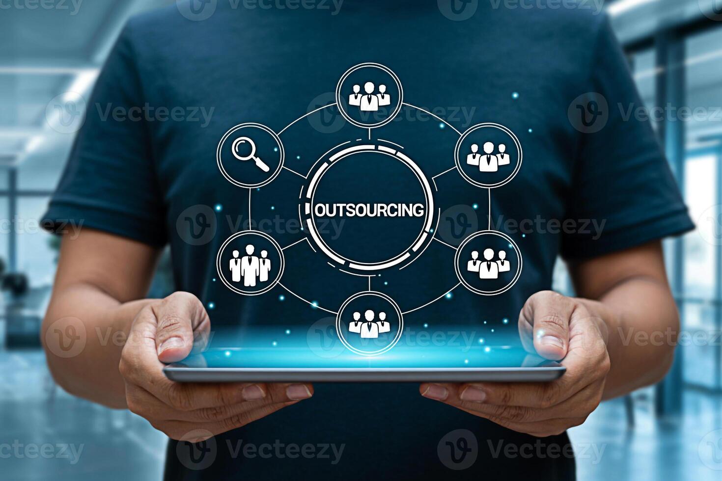 Man holding a glowing tablet displaying an outsourcing network diagram in a modern office showcasing global business connections and efficient resource management for business growth and strategic par photo
