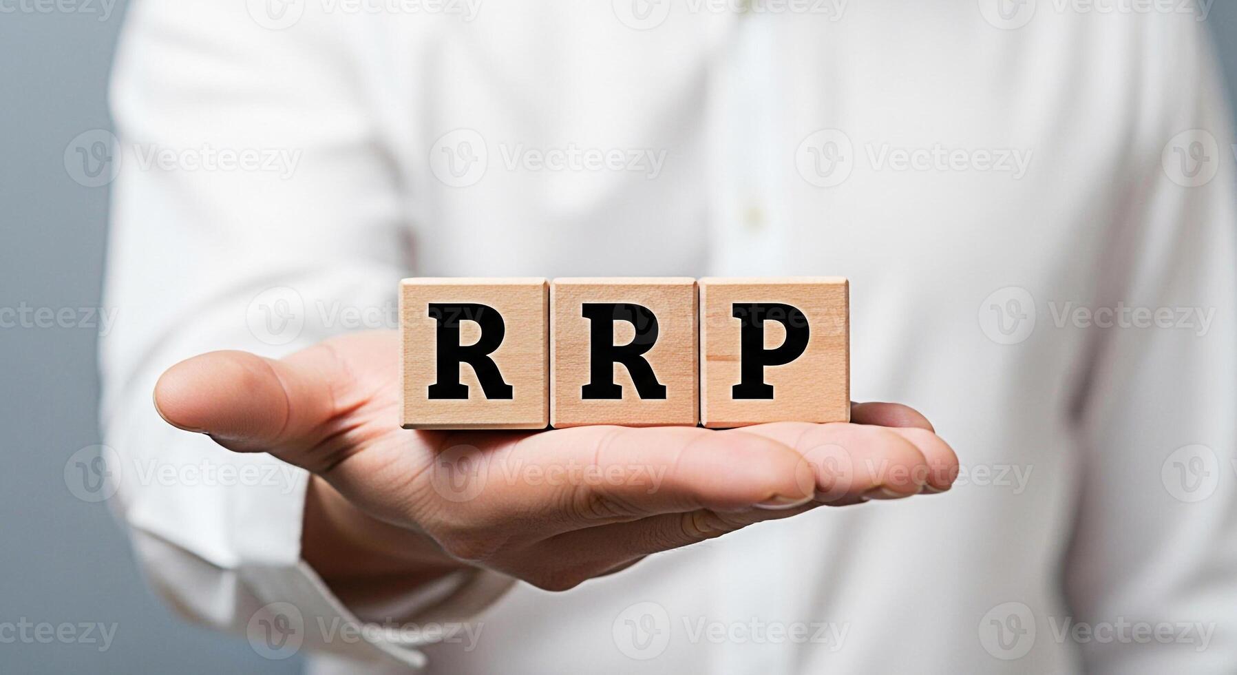 Closeup of a hand presenting wooden blocks spelling RRP against a neutral background symbolizing retail price strategy and consumer value emphasizing transparency and informed purchasing decisions photo