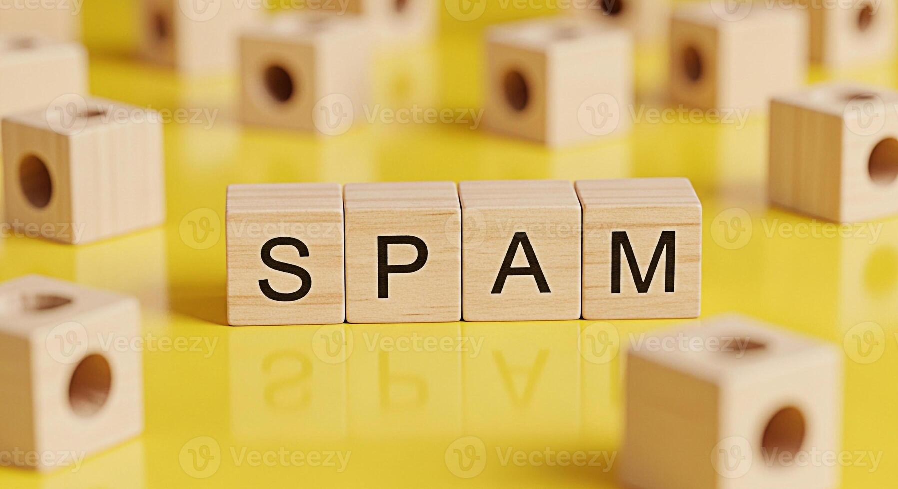 Wooden blocks spelling SPAM on a bright yellow surface representing unwanted emails and messages creating a sense of frustration and the need for digital security and online protection measures photo