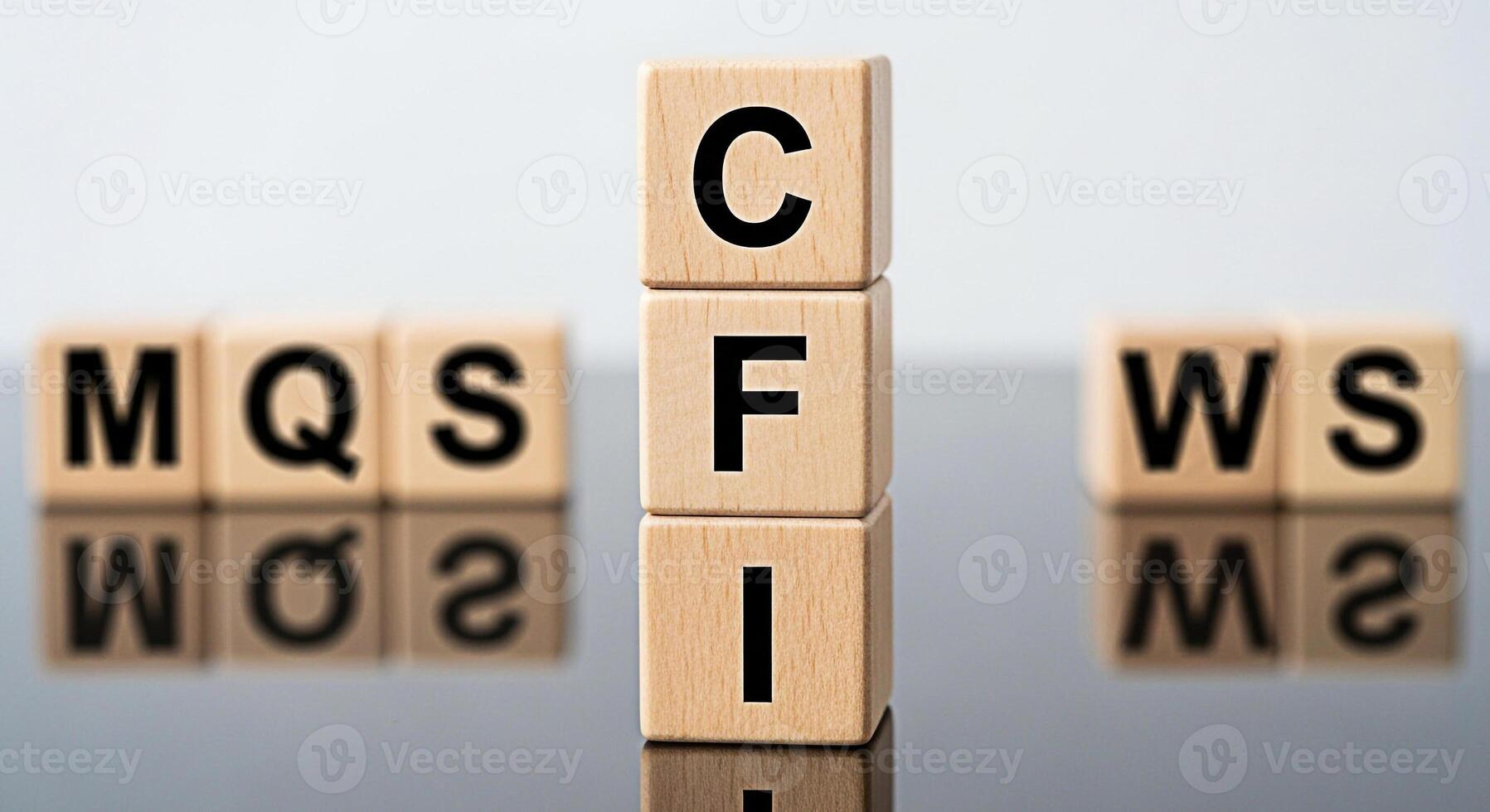 Wooden blocks displaying CFI stacked vertically on a reflective surface representing corporate finance and investment surrounded by MQS and WS blocks symbolizing market quality and web services in a b photo