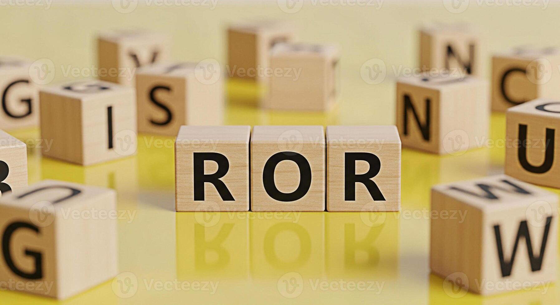 Wooden blocks spelling ROR on a glossy yellow surface surrounded by other lettered blocks creating a playful and educational atmosphere symbolizing return on risk and the importance of strategic decis photo