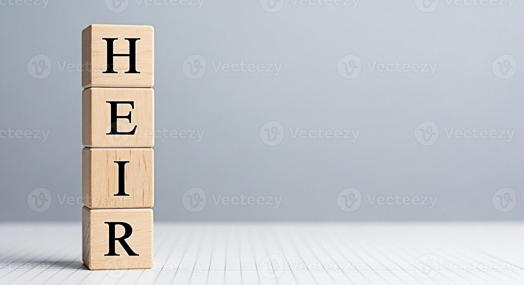 Wooden blocks spelling HEIR stacked on a white grid surface against a soft gray background symbolizing inheritance succession and legacy planning for future generations with a sense of responsibility photo