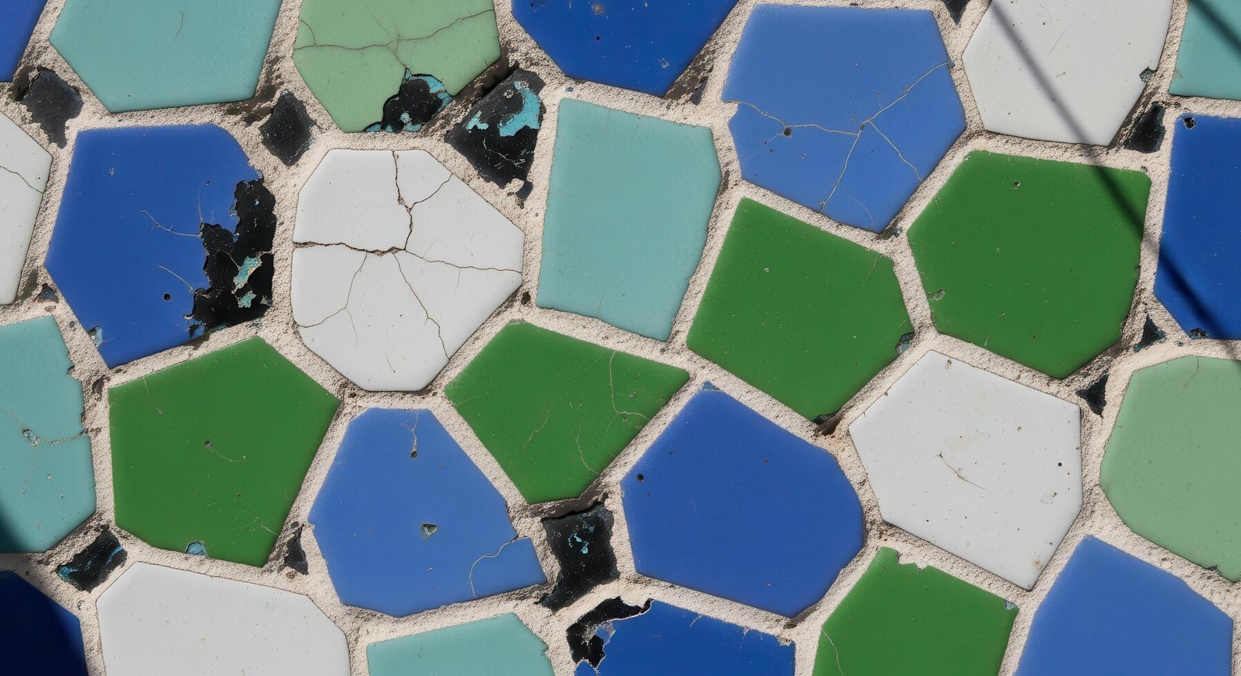 Close-up shot of a colorful mosaic tile pattern with various geometric shapes, showing texture, cracks, and imperfections, evoking artistic and decorative design photo
