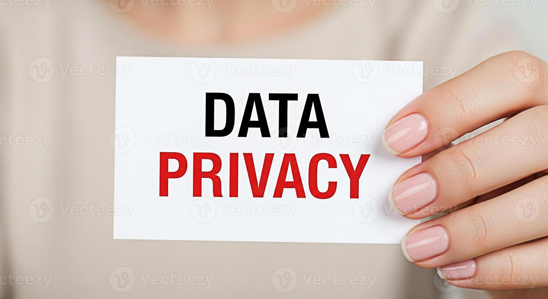 Closeup of a manicured hand holding a card that reads Data Privacy in a neutral setting emphasizing the importance of digital security and personal information protection in the modern age photo